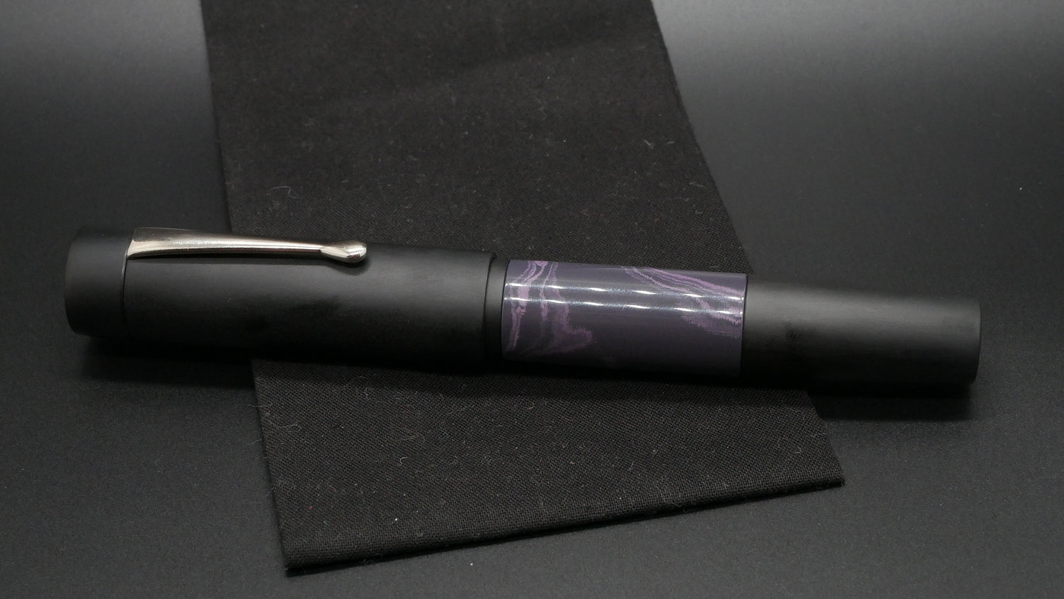 Orville - oversize - Matte Black and Purple Rain swirl ebonites, doublet - clip - #6 nib