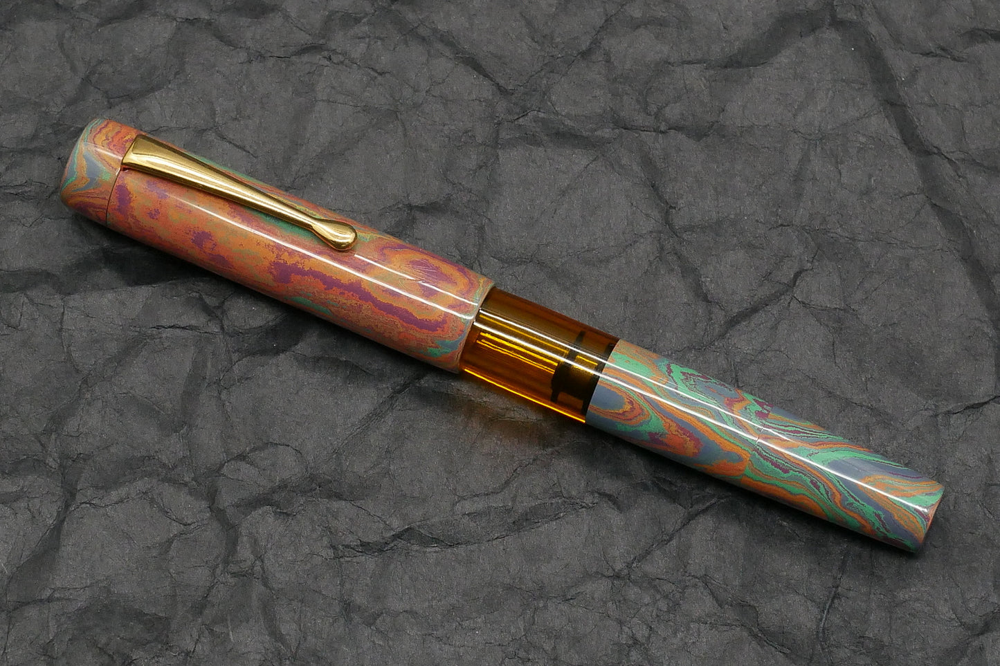 Orville - Medium - Rainbow ebonite, orange acrylic - clip - piston - #6 nib