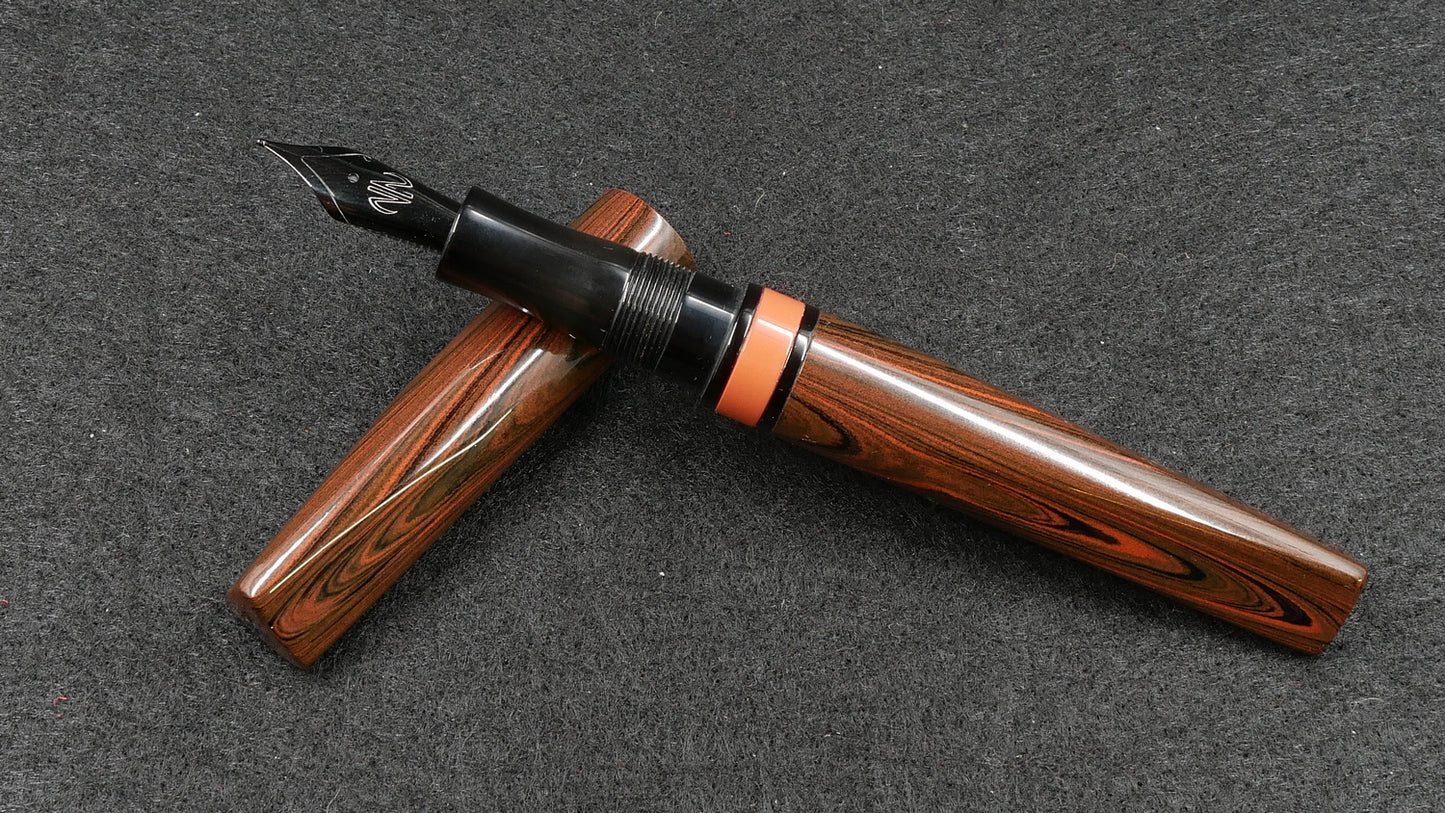 Prospector - Small - Nikko Orange triple ripple and solid black ebonite - Jowo #6 nib