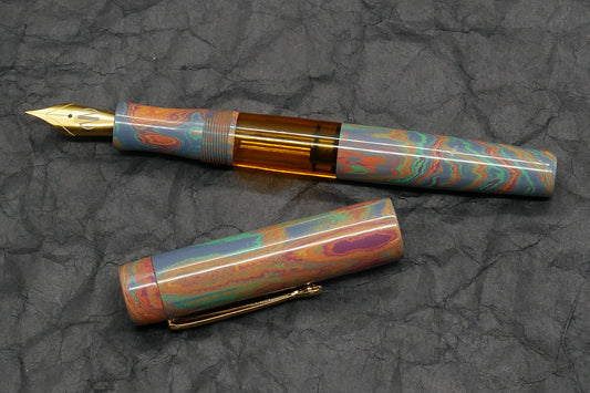 Orville - Medium - Rainbow ebonite, orange acrylic - clip - piston - #6 nib