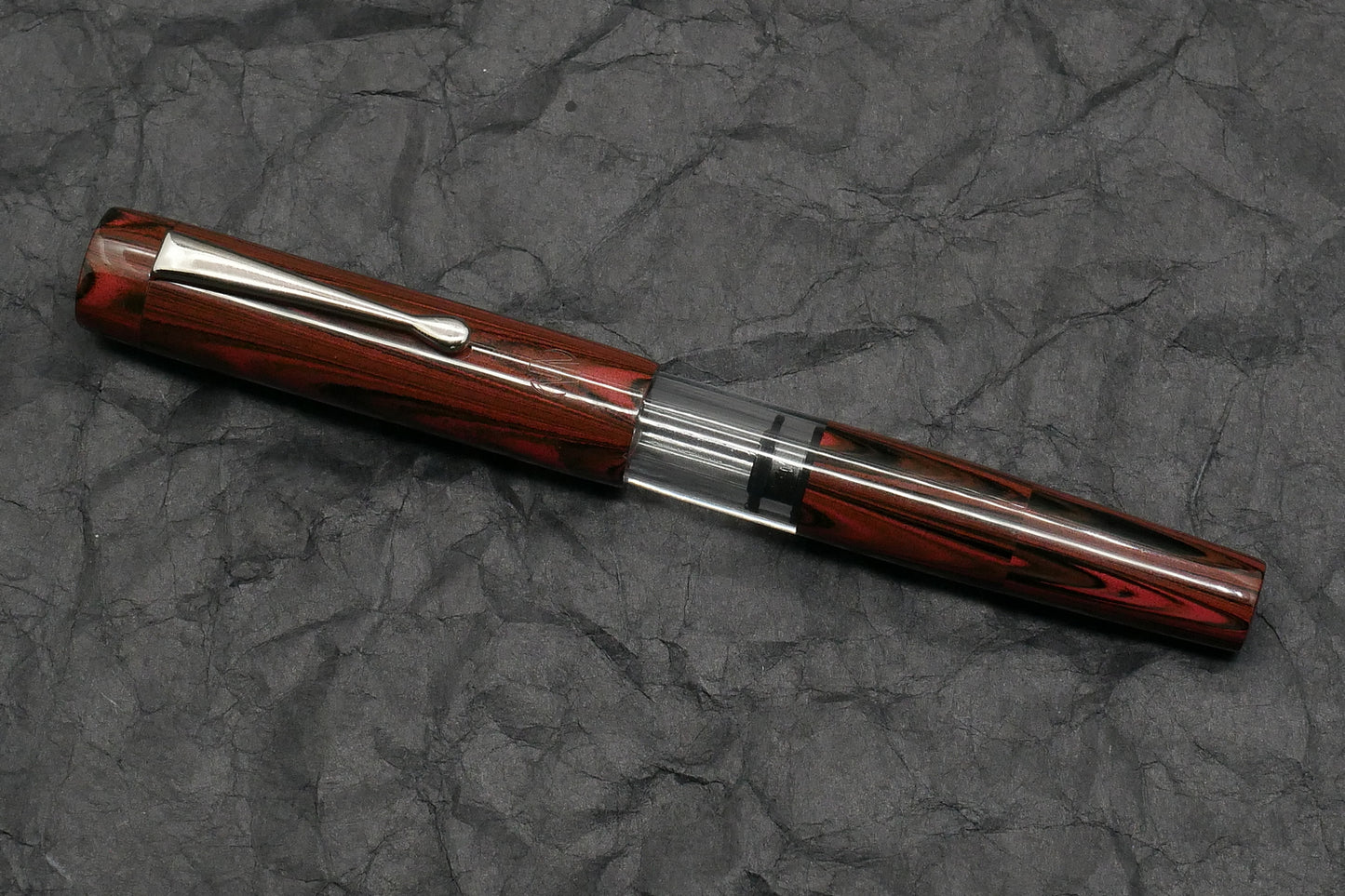 Orville - Medium - Red ripple ebonite, clear acrylic - clip - piston - #6 nib