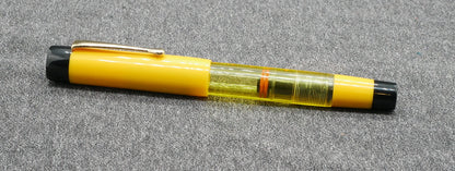 Orville - Medium - Solid Yellow and black, clear yellow acrylics - clip - piston - #6 nib