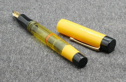 Orville - Medium - Solid Yellow and black, clear yellow acrylics - clip - piston - #6 nib