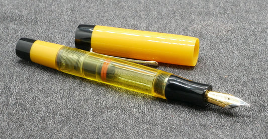 Orville - Medium - Solid Yellow and black, clear yellow acrylics - clip - piston - #6 nib